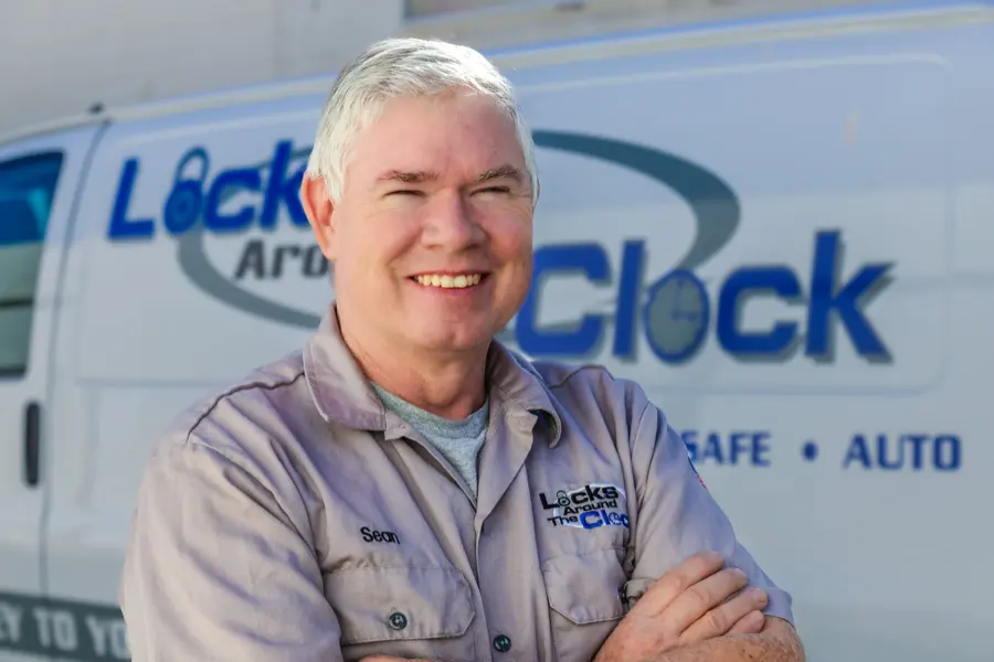 Sean Cahill, founder and master locksmith at Locks Around the Clock, standing in front of a branded service van in Palm Desert