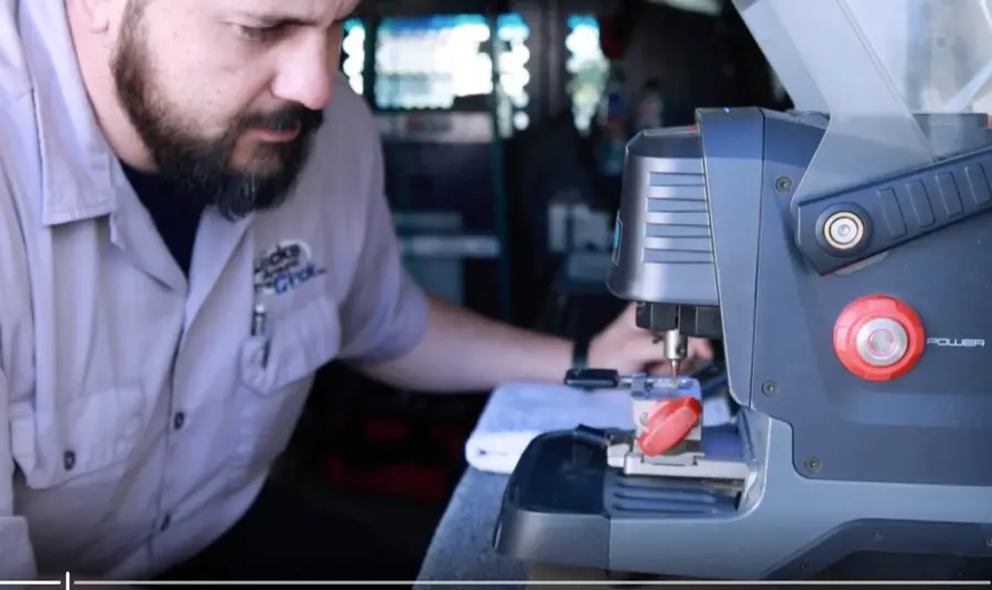 Steven, automotive key specialist at Locks Around the Clock, cutting a car key on the service van key-cutter